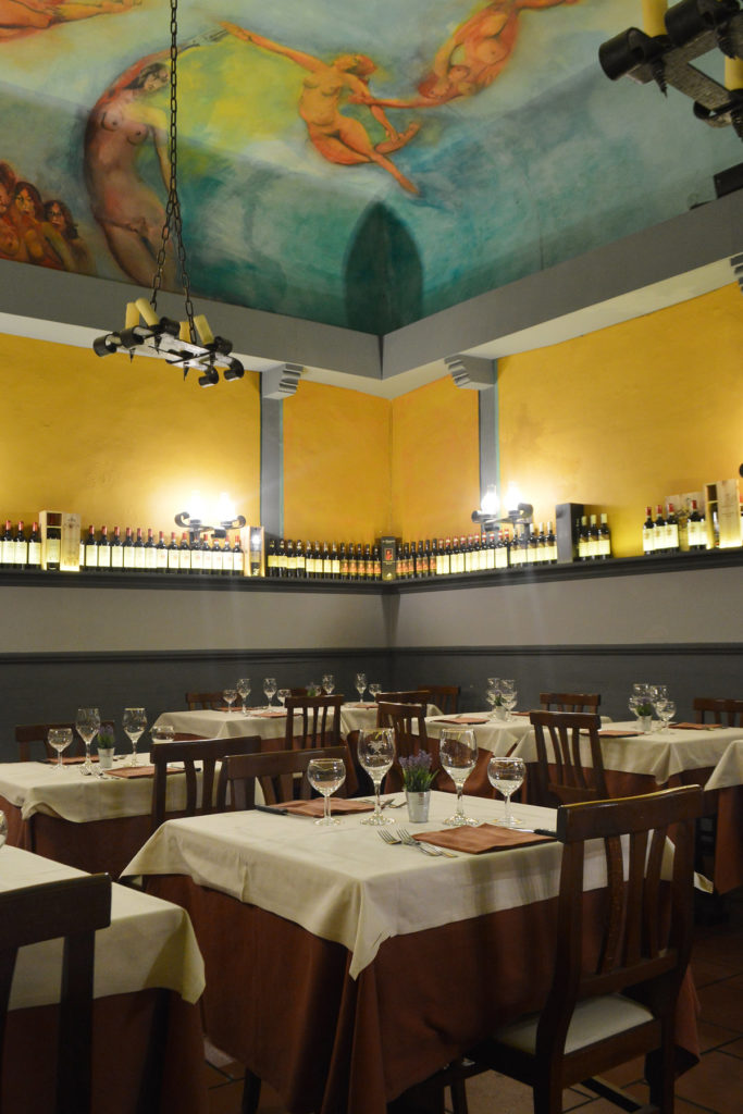 Image shows one of the rooms at Vecchia Firenze Restaurant with frescoed ceiling